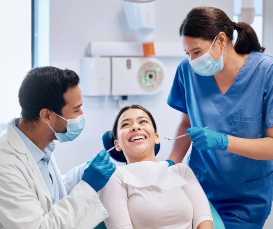 Happy patient talking with dental team