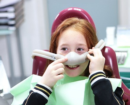 Smiling child wearing nitrous oxide mask