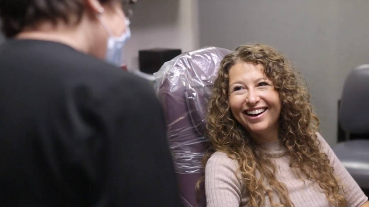 Woman in dental chair grinning at her dentist in Beachwood