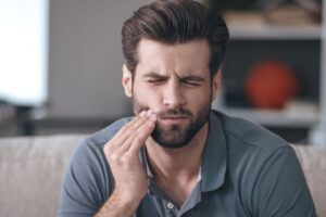 Man suffering from toothache pain